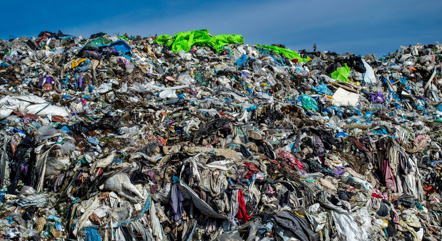 A pile of discarded textiles in a landfill