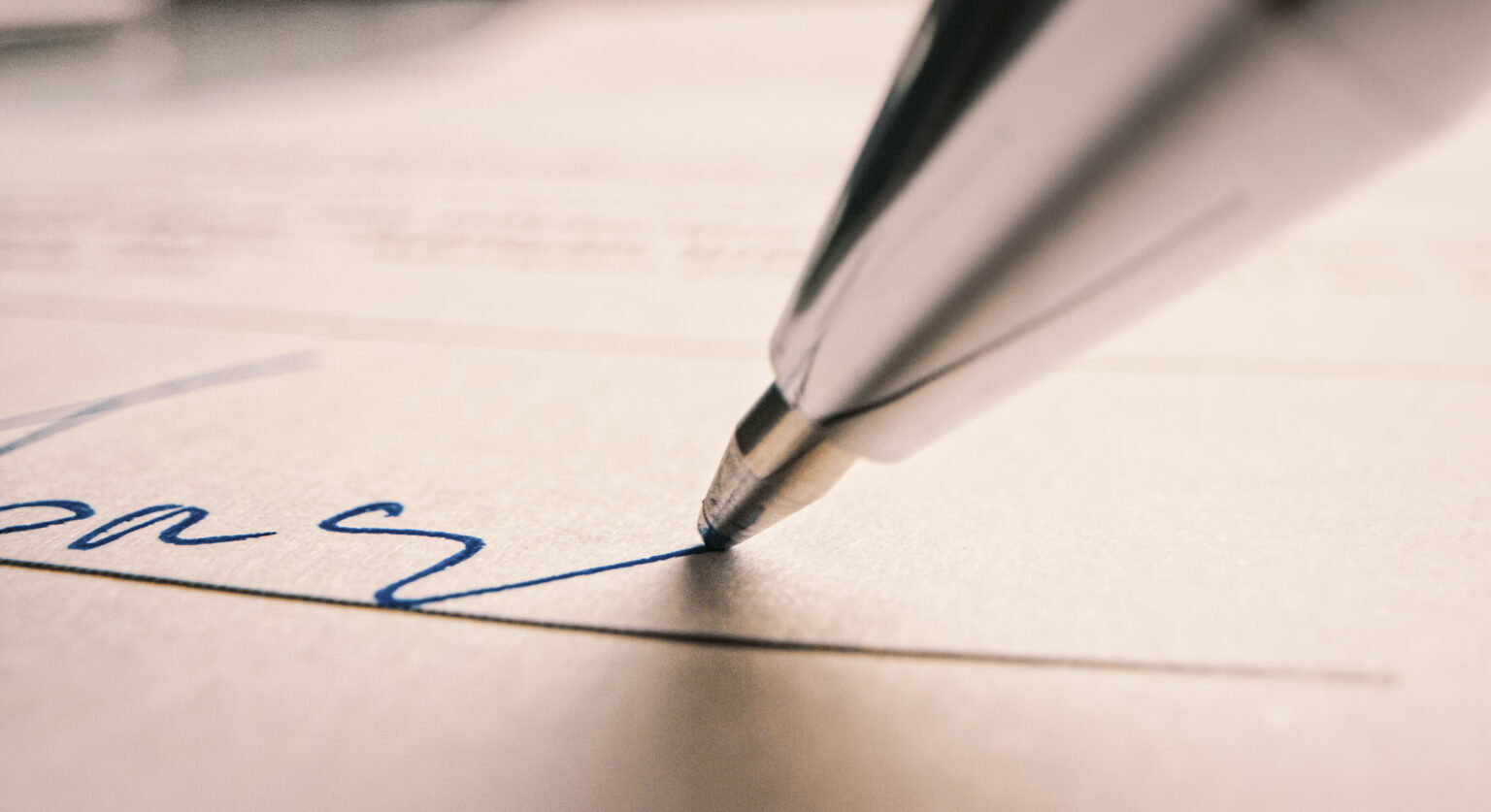 A pen writing on paper