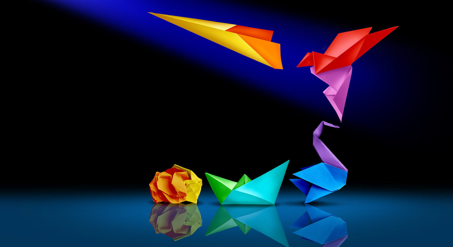 Crumbled paper, origami boat, origami bird, flying origami bird and a paper airplane