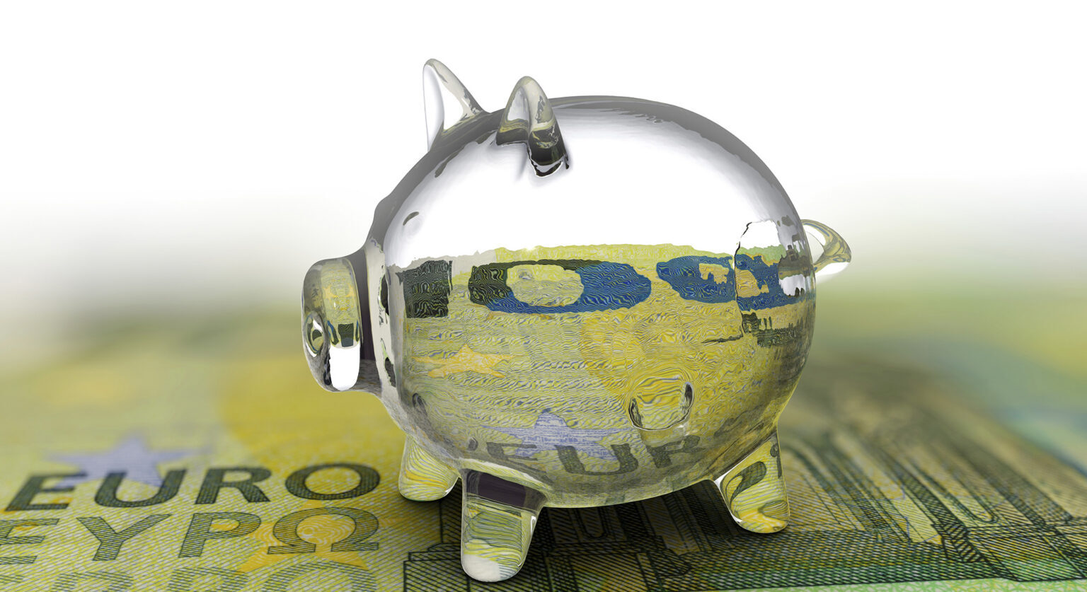 A glass piggy bank on top of a euro note
