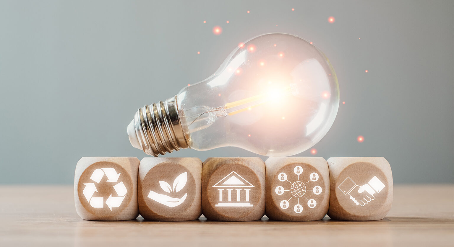 A light bulb sitting on top of blocks that represent the many considerations that boards of directors have