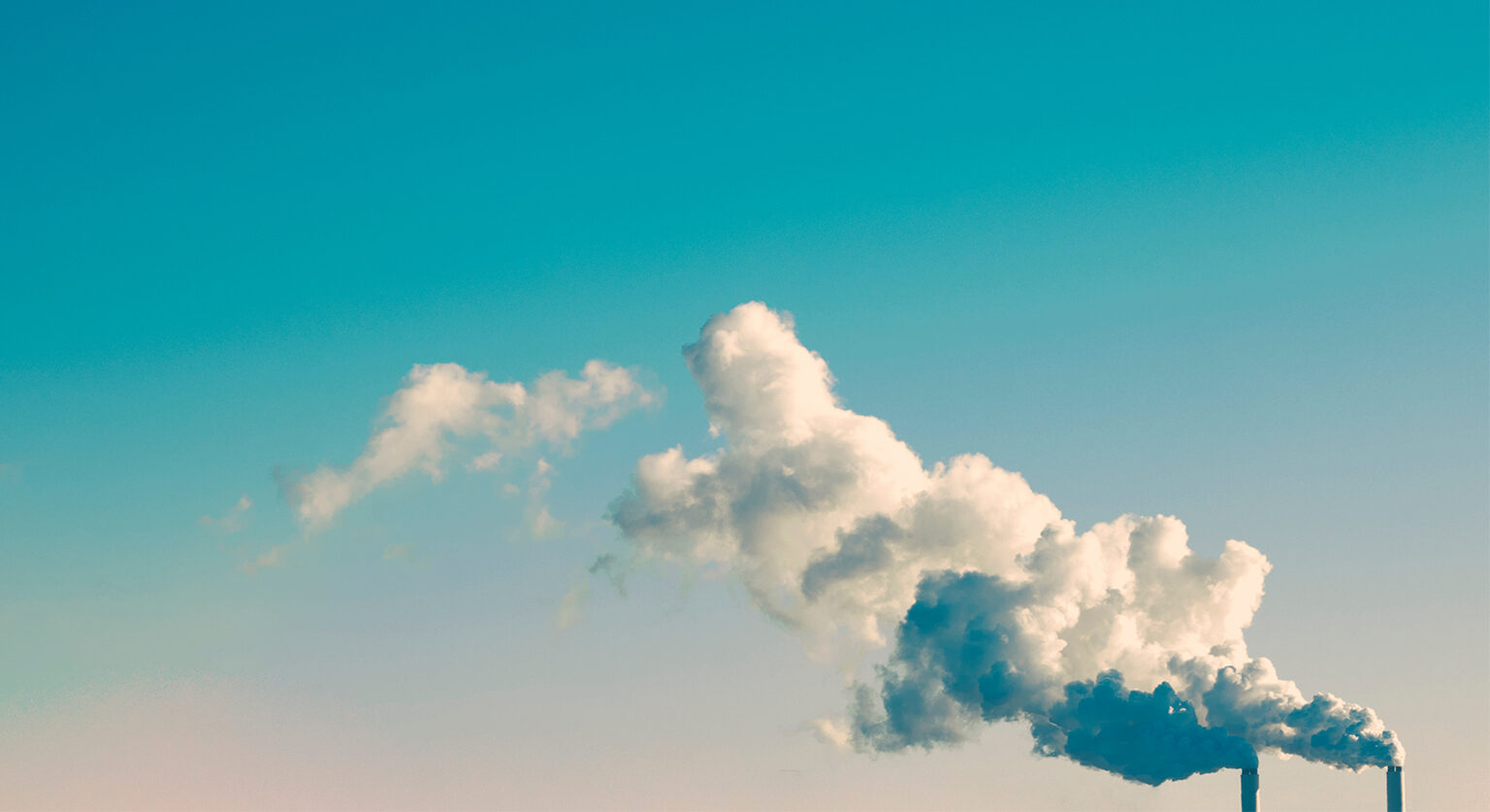 Two smoke stakes release carbon into the atmosphere