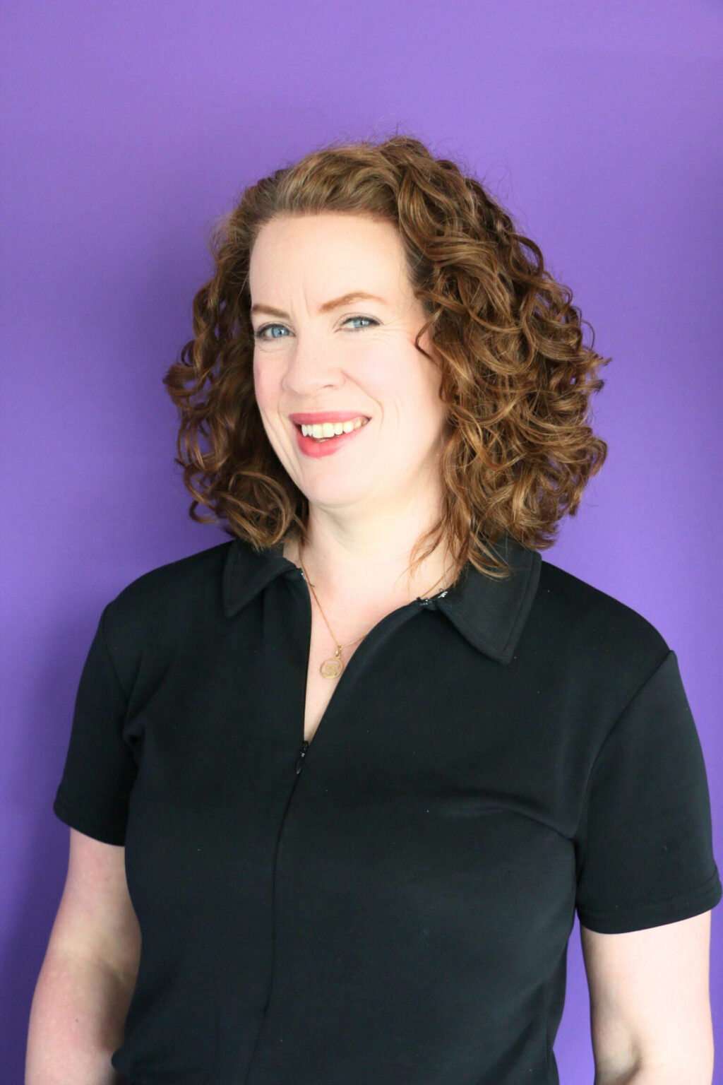 A profile photo of Susan Kilcline, founder of OwnIt Advisory, pictured against a colourful purple background.
